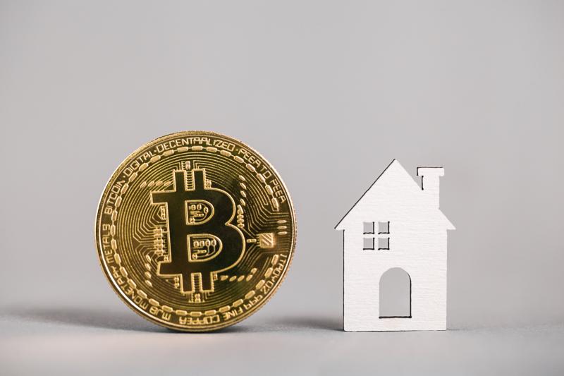Bitcoin next to a house