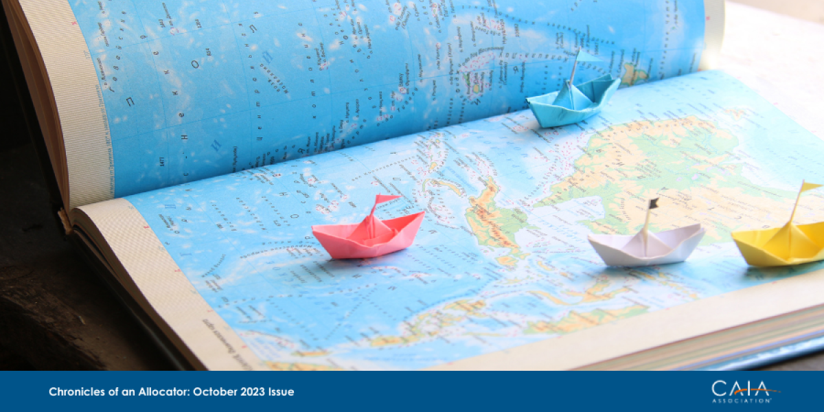 Origami paper boats on a map